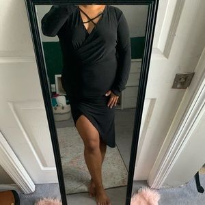 Long sleeve black dress with an asymmetric cut
